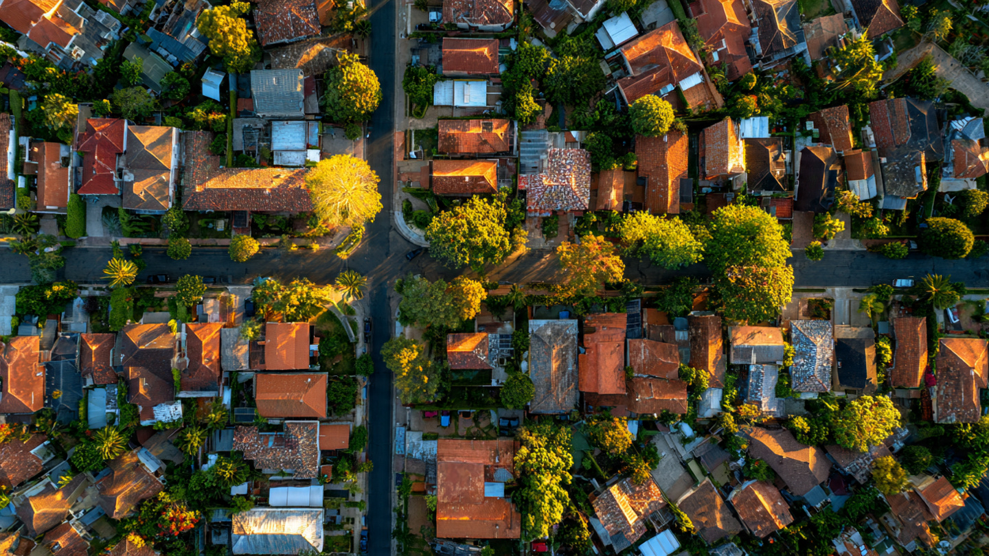 Aerial view of suburban residential rooftops in varying conditions